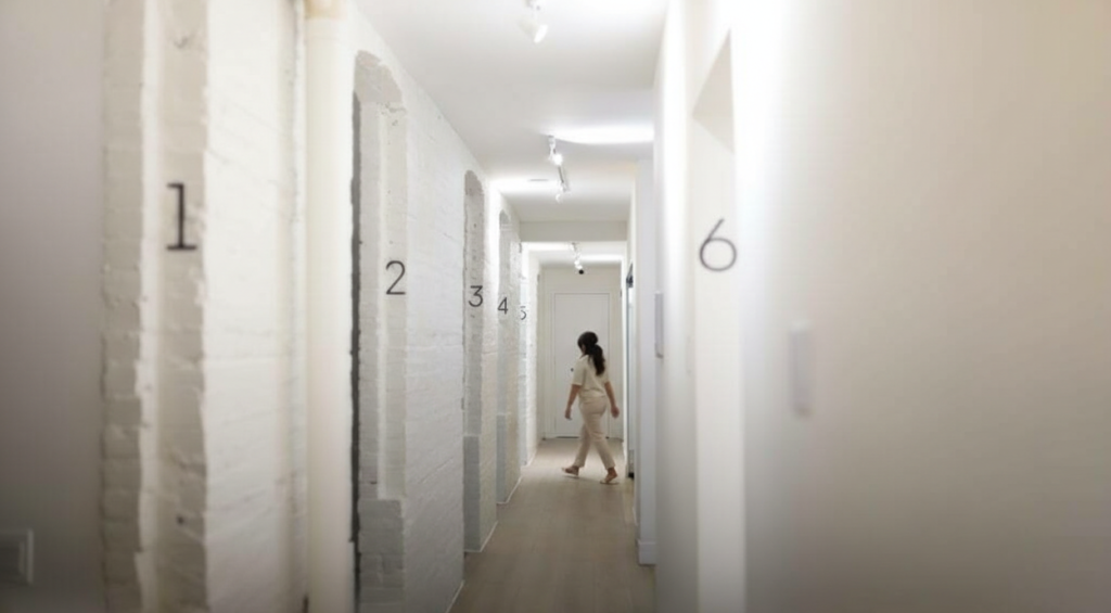 Hallway with numbered doors at SMILELOUNGE in Brooklyn, NY